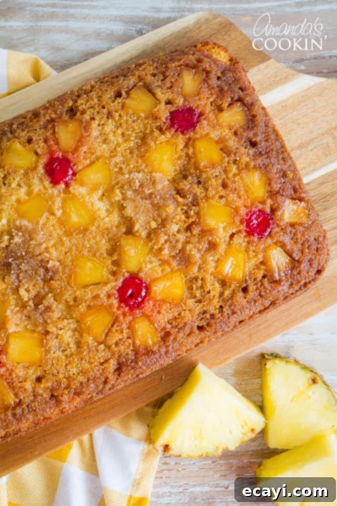 Before baking, this pineapple upside down cake is carefully arranged with pineapple and cherries over a buttery brown sugar base, ready for the yellow cake batter. #pineappleupsidedowncake #bakingprep #homemadecake Prepared Pineapple Upside Down Cake in a Baking Pan