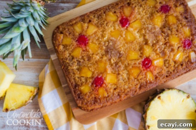 The smooth yellow cake batter has been poured over the pineapple and cherry topping, ready to bake into a golden, delicious pineapple upside down cake. #cakeprep #bakingcake #homemade Pineapple Upside Down Cake Ready for Baking