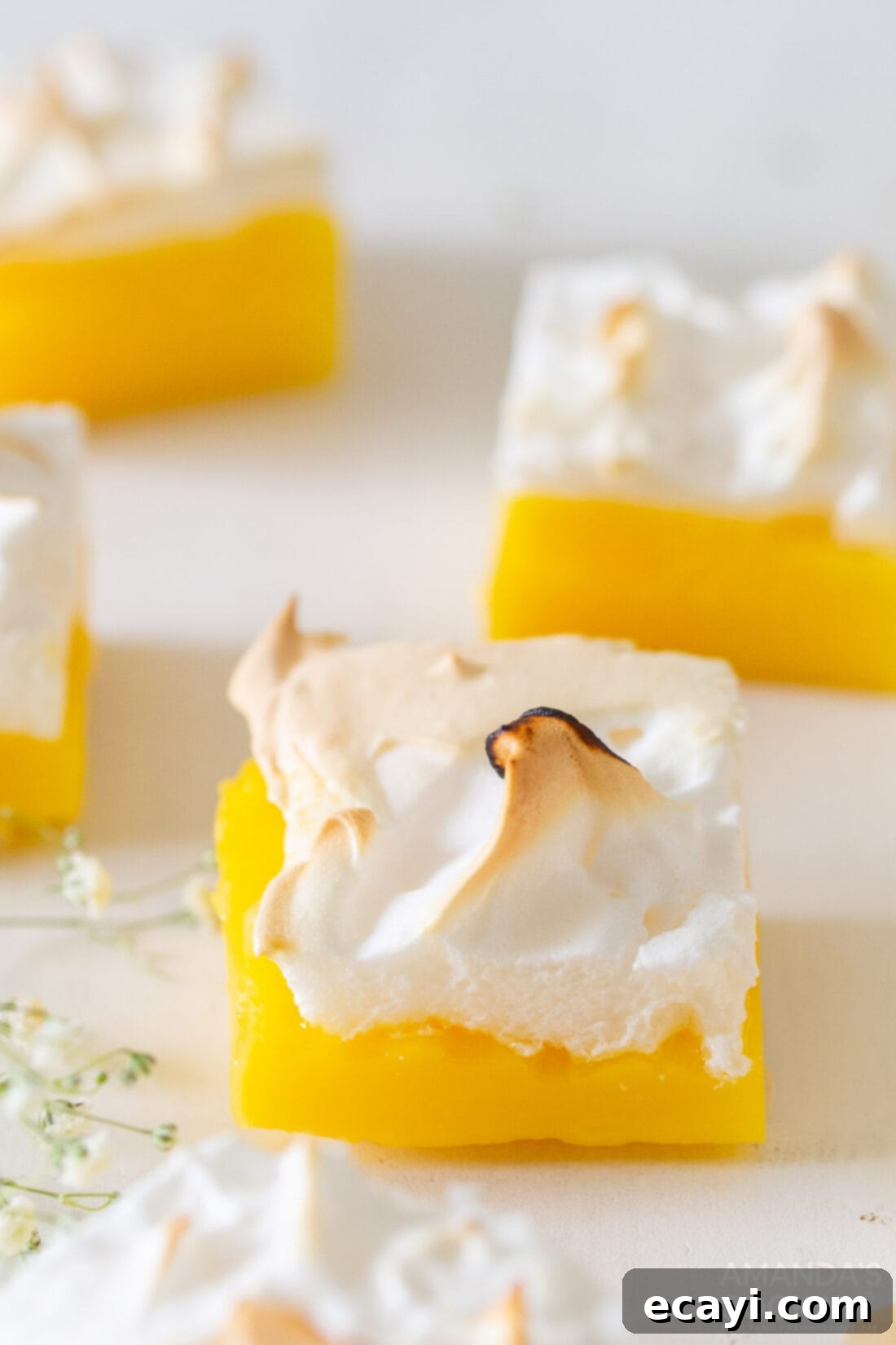 Tangy Lemon Meringue Pie Bars 13 Lemon Meringue Pie Bars arranged neatly on a serving platter