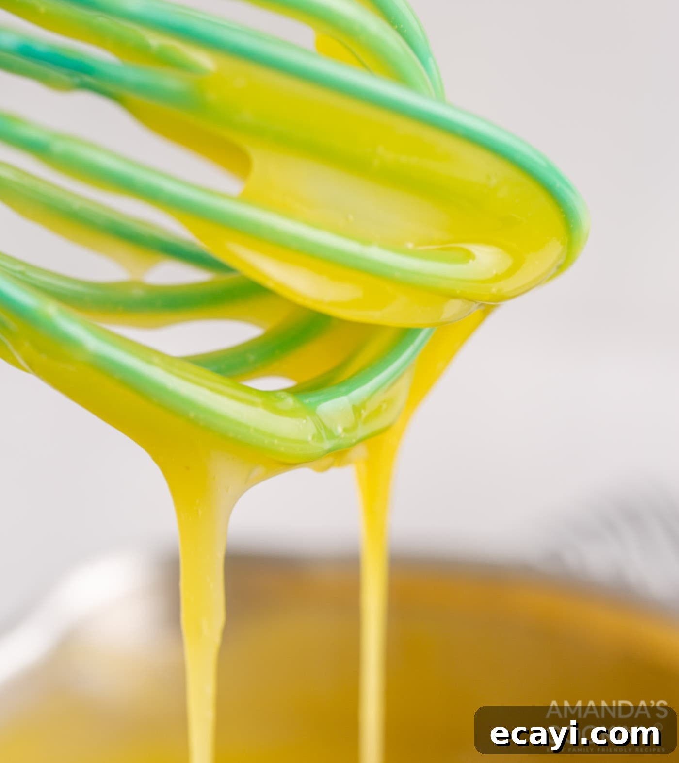Tangy Lemon Meringue Pie Bars 6 Egg mixture being drizzled into a saucepan with a whisk