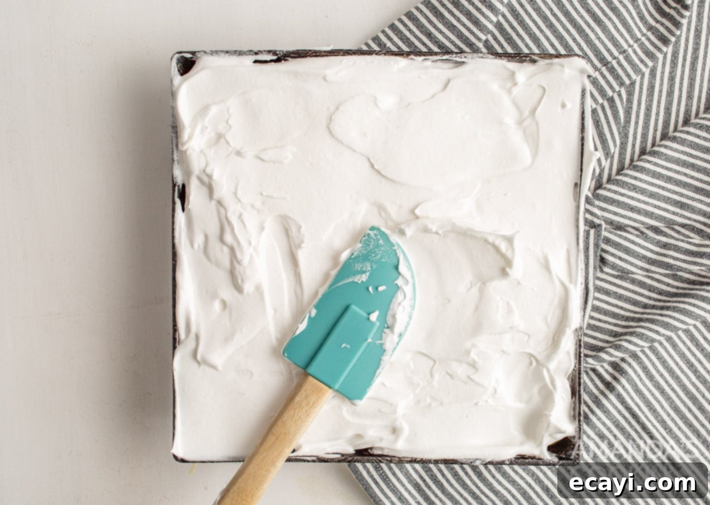 Tangy Lemon Meringue Pie Bars 9 Flattening meringue topping on top of lemon curd in a pan