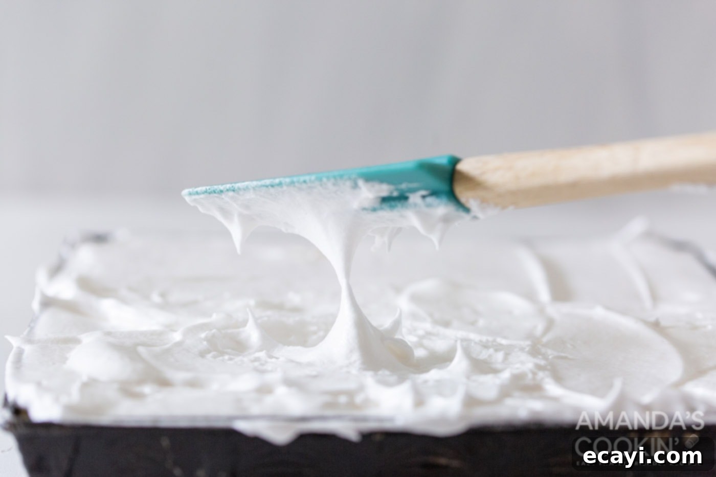 Tangy Lemon Meringue Pie Bars 10 Rubber spatula making lemon meringue peaks in the pan
