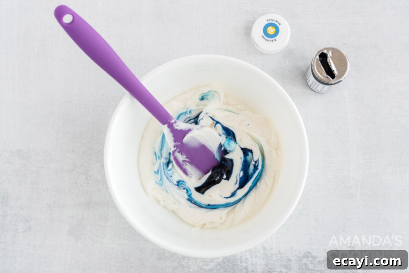 Stars and Stripes Sweet Treats 6 mixing blue food coloring into white frosting