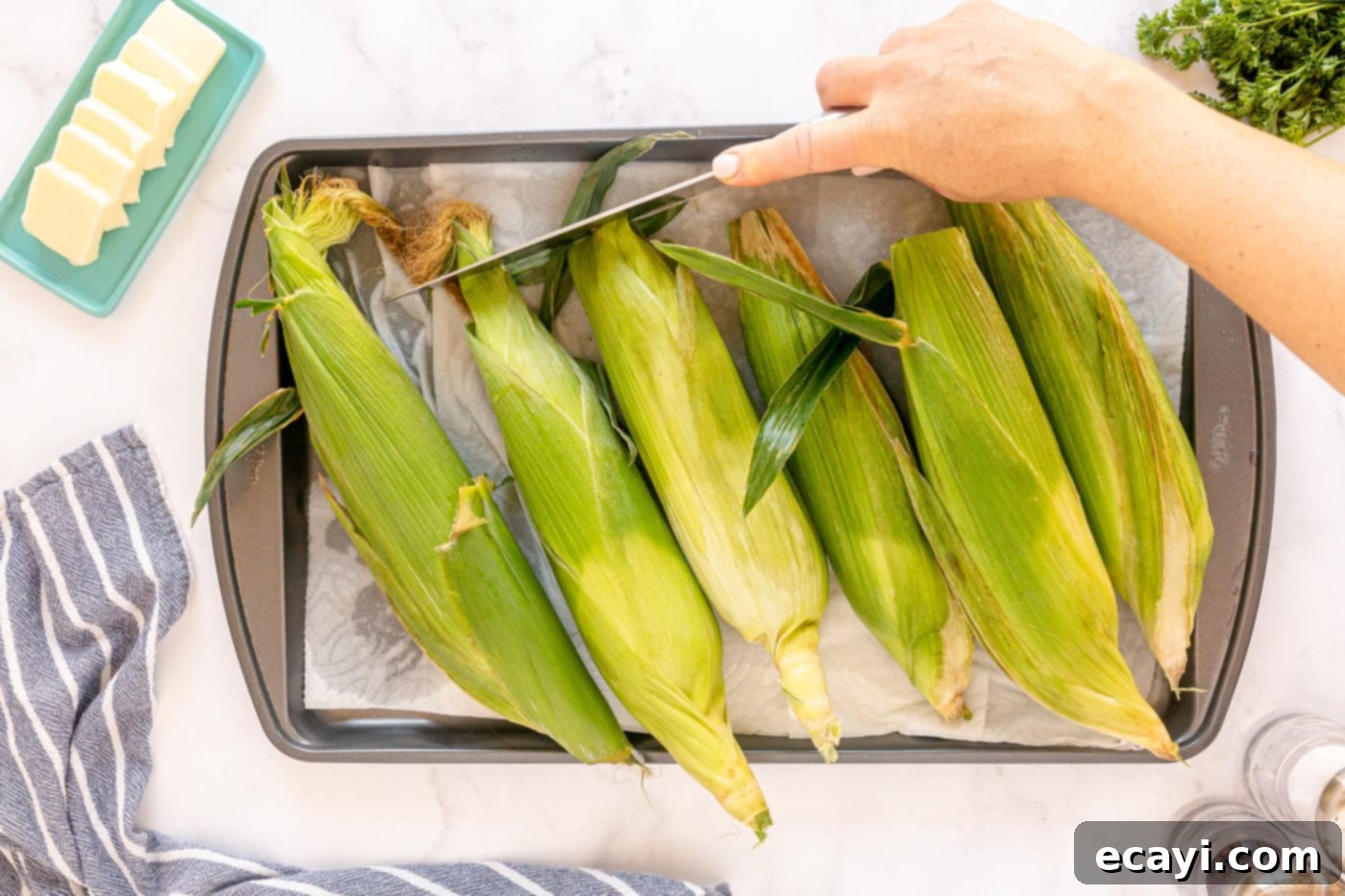 Golden Grilled Corn 6 Corn drying on a baking sheet with paper towels after soaking