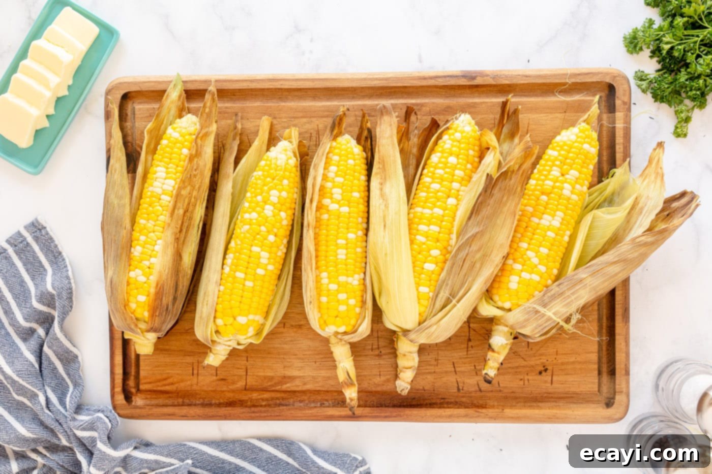 Golden Grilled Corn 9 Peeled grilled corn on the cob on a cutting board, ready to serve