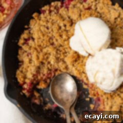 Sweet & Tart Rhubarb Crumble 9 Close up photo of Rhubarb Crisp in a skillet topped with ice cream
