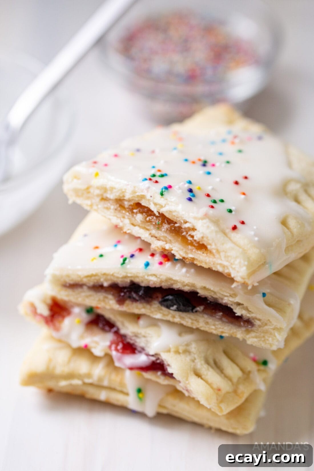 Whip Up Your Own Pop Tarts 3 Stack of homemade pop tarts cut in half, showcasing the vibrant jam filling and flaky golden crust
