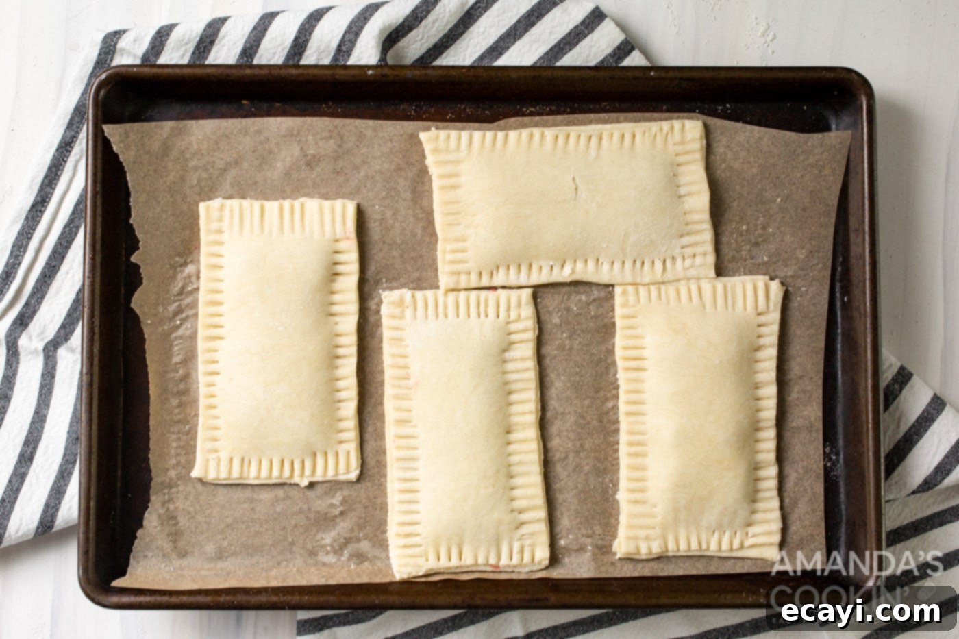 Whip Up Your Own Pop Tarts 8 Unbaked pastries on a baking sheet, sealed and beautifully crimped with a fork along the edges