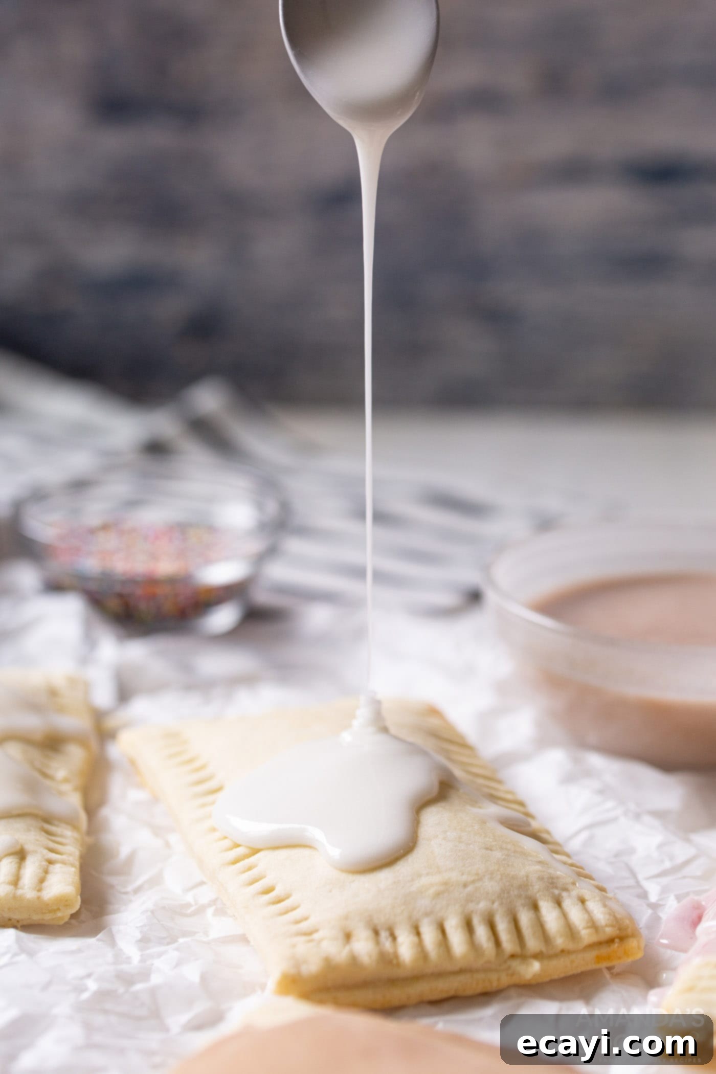 Whip Up Your Own Pop Tarts 10 Thick, white glaze being artfully drizzled over a warm, golden homemade pop tart