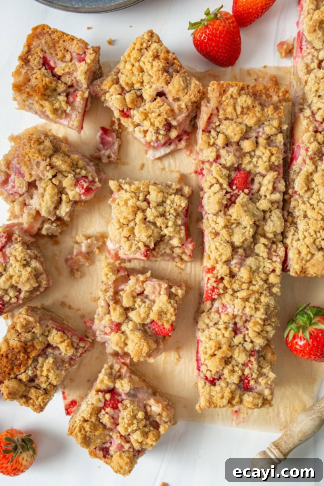 Strawberry Rhubarb Crumbly Bars 2 Freshly baked Strawberry Rhubarb Crumble Bars sliced into individual squares, showing the vibrant fruit filling and golden oat topping.
