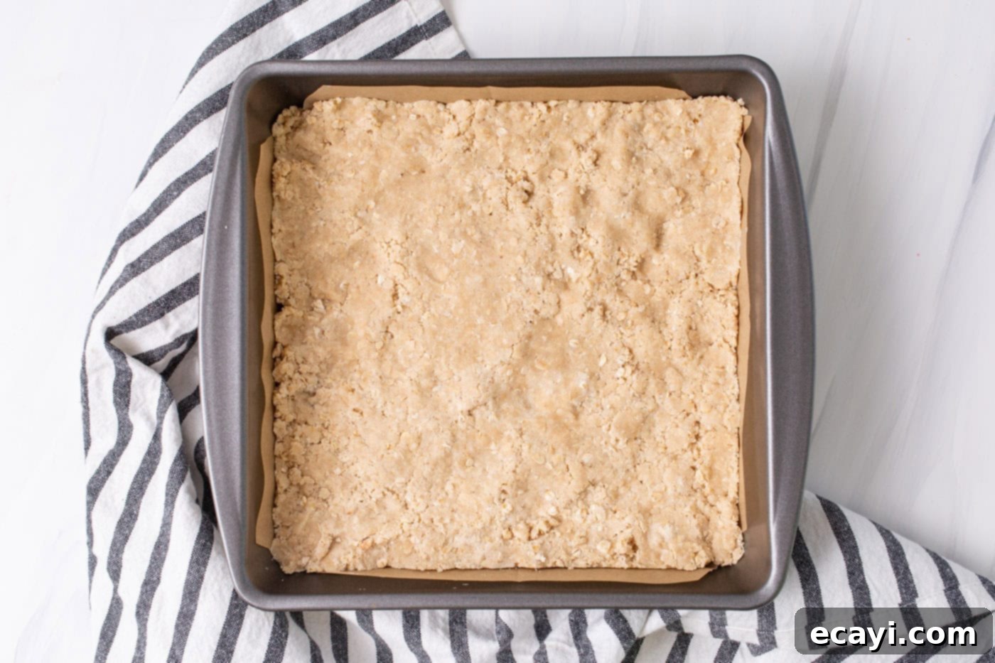 Strawberry Rhubarb Crumbly Bars 6 Rhubarb crumble bars crust firmly pressed into a parchment-lined 8x8 baking pan.