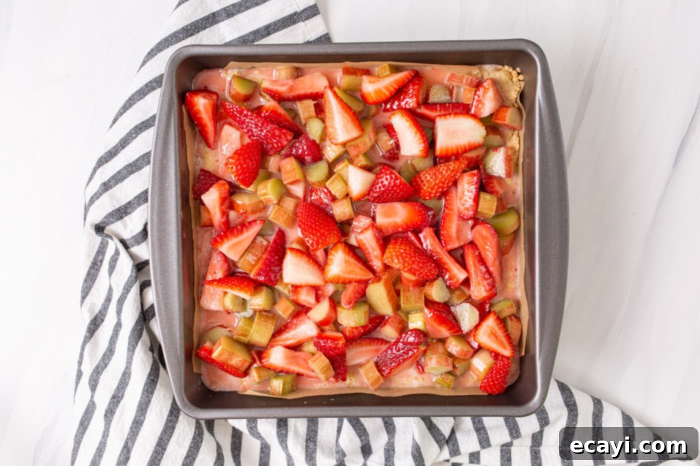 Strawberry Rhubarb Crumbly Bars 7 Fresh strawberries and rhubarb mixed with lemon juice, sugar, and cornstarch, spooned over the crumble crust in a baking pan.