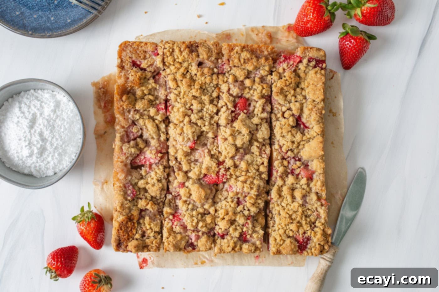 Strawberry Rhubarb Crumbly Bars 9 Perfectly sliced Strawberry Rhubarb Crumble Bars arranged neatly on a cutting board, ready to be served.