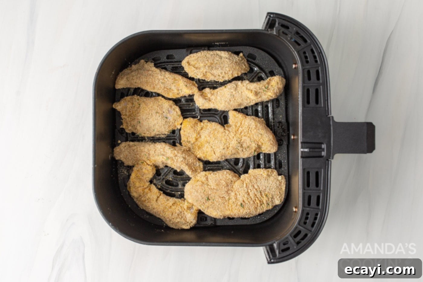 Crispy Air Fryer Chicken Tenders 6 breaded chicken tenders in air fryer basket