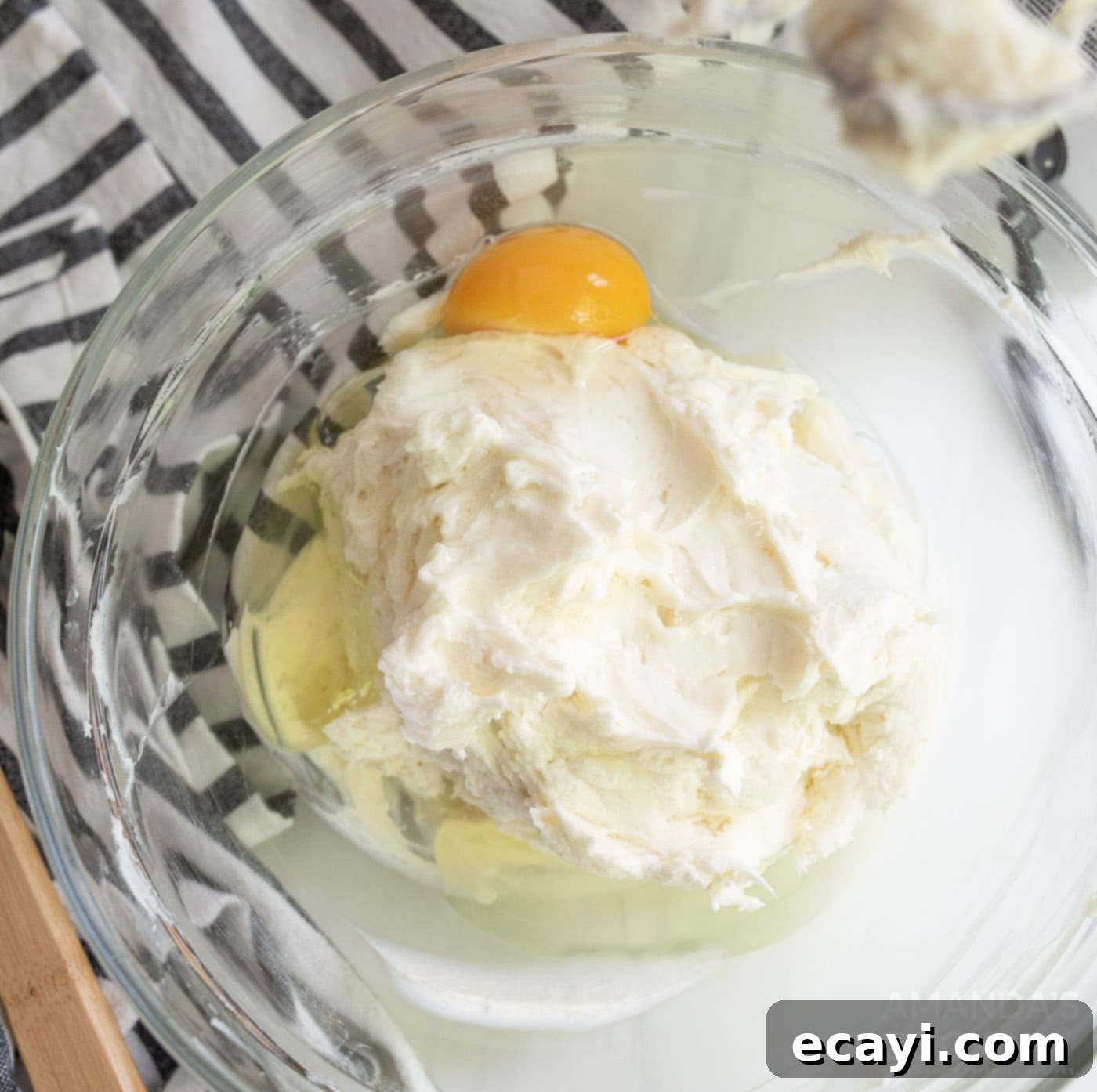 Silky Smooth Instant Pot Cheesecake 7 lemon juice, vanilla extract, and an egg in bowl with cream cheese mixture