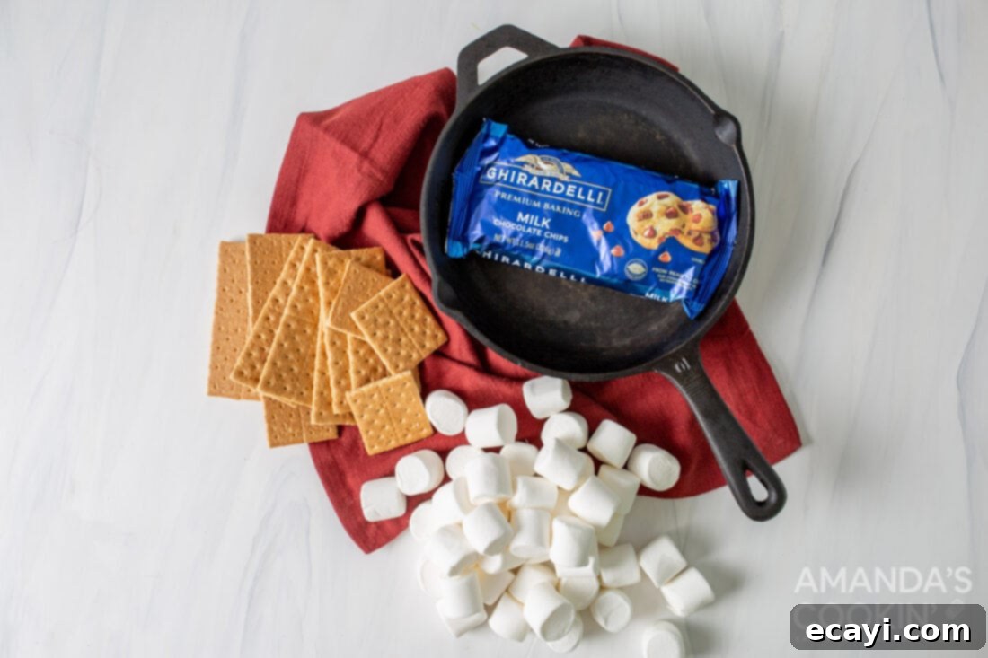Gooey S'mores Skillet 4 All the simple ingredients for making homemade S'mores Dip laid out: milk chocolate chips and regular sized marshmallows.