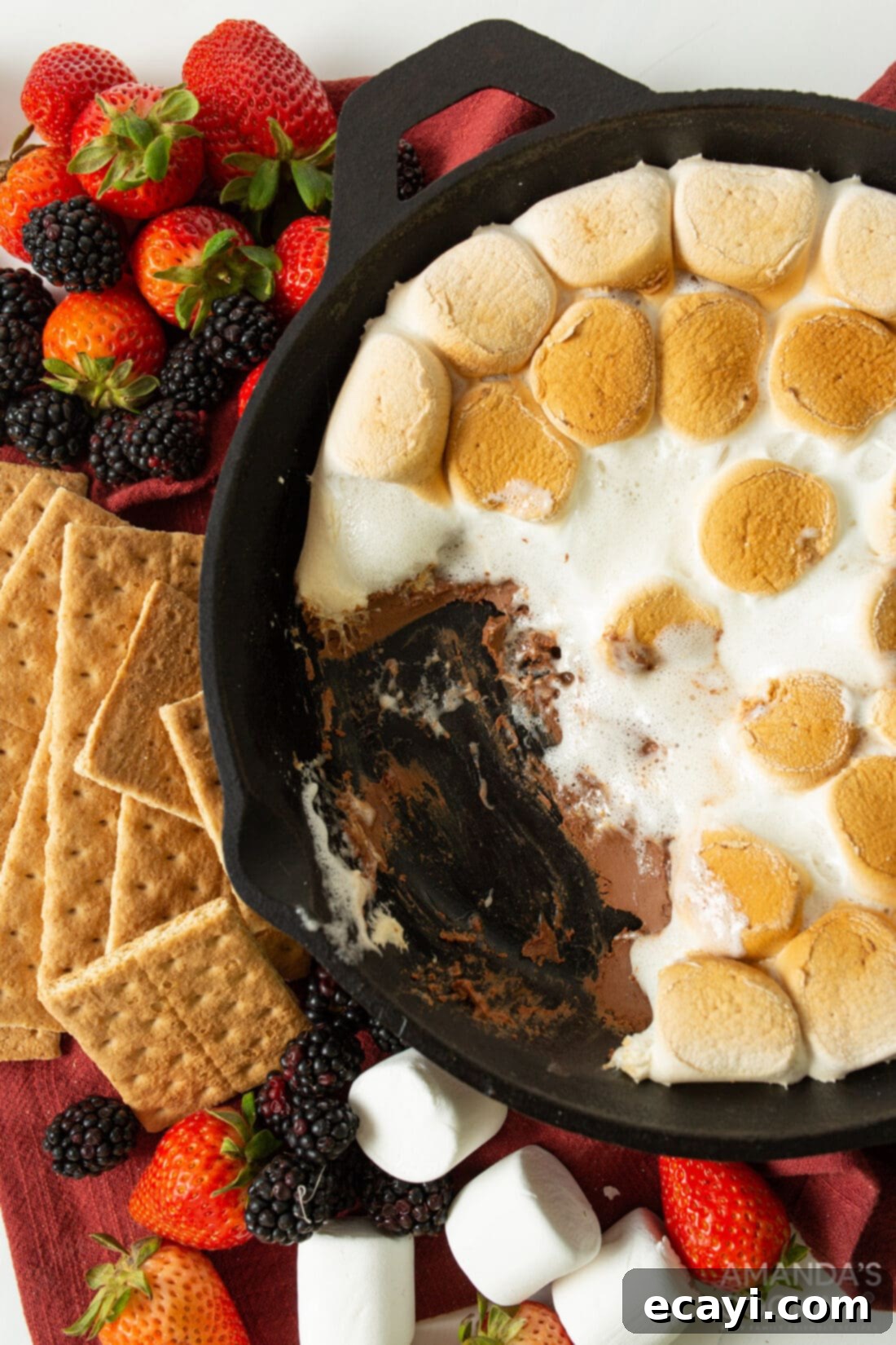 Gooey S'mores Skillet 8 Close-up of a perfectly baked S'mores Dip in a cast-iron skillet, showcasing its golden-brown marshmallows and rich chocolate base.