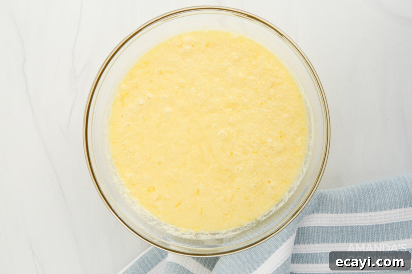 Effortless Instant Pot Lemon Curd 5 lemon curd mixture in a mixing bowl, showing its creamy texture before cooking