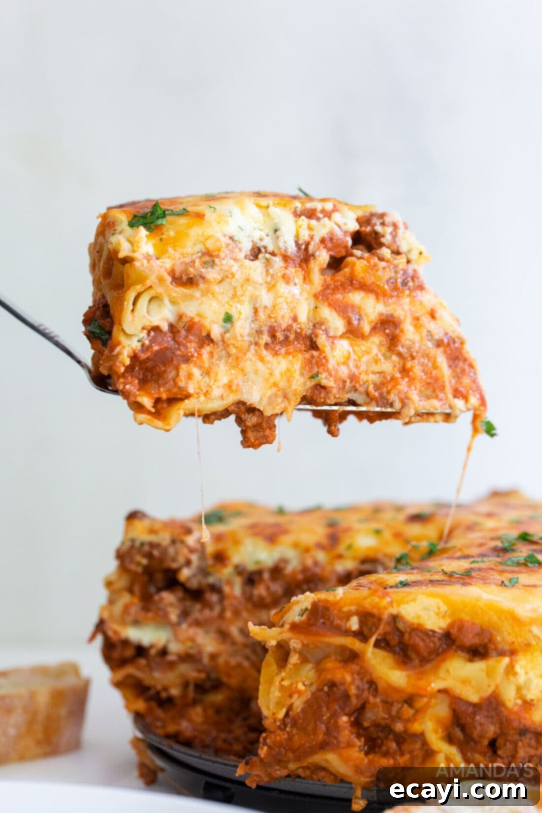 Quick Instant Pot Lasagna 2 spatula lifting slice of Instant Pot Lasagna, showcasing layers of meat, cheese, and noodles