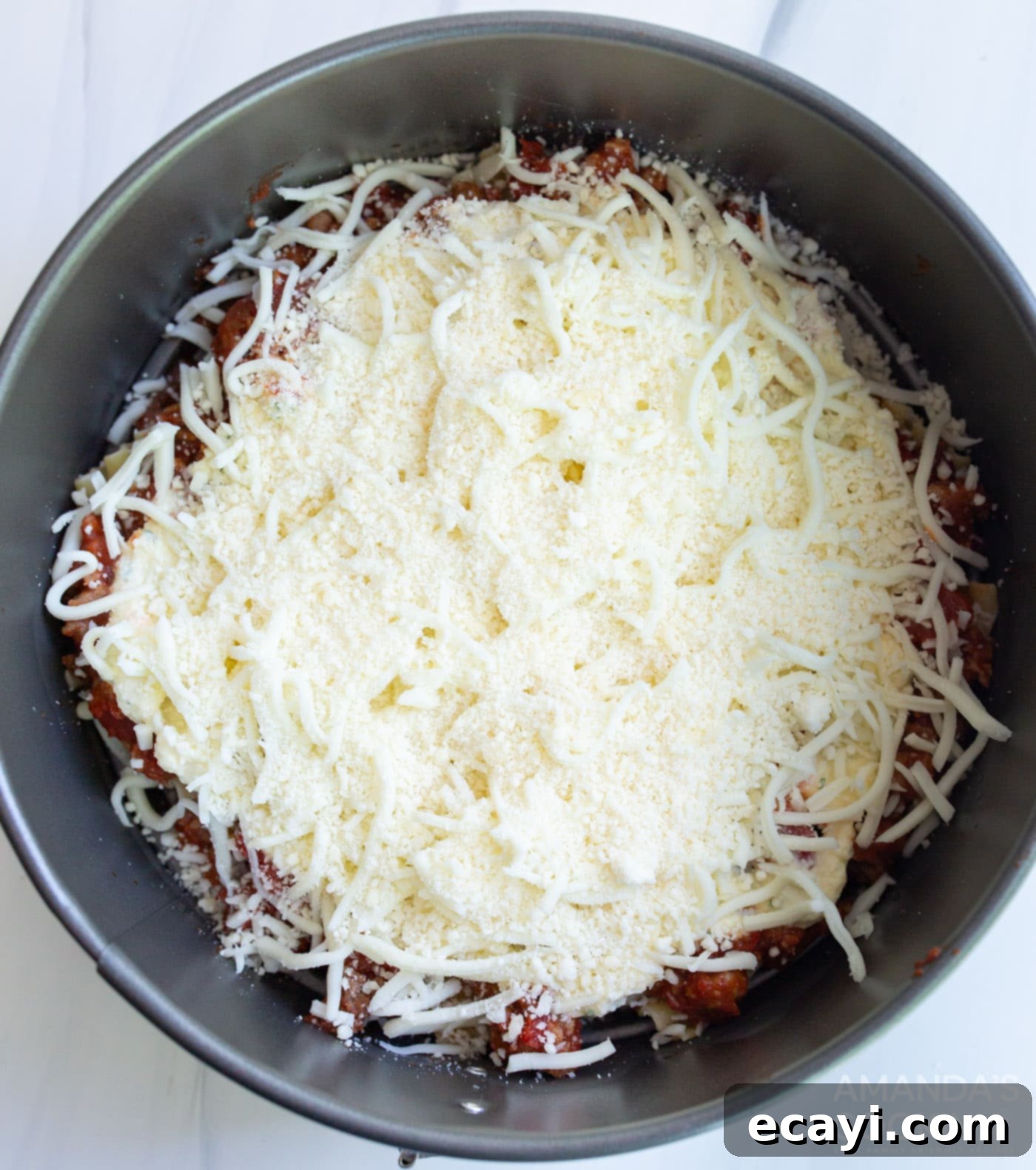 Quick Instant Pot Lasagna 10 Generous layer of mozzarella and Parmesan cheese topping the lasagna in a springform pan.