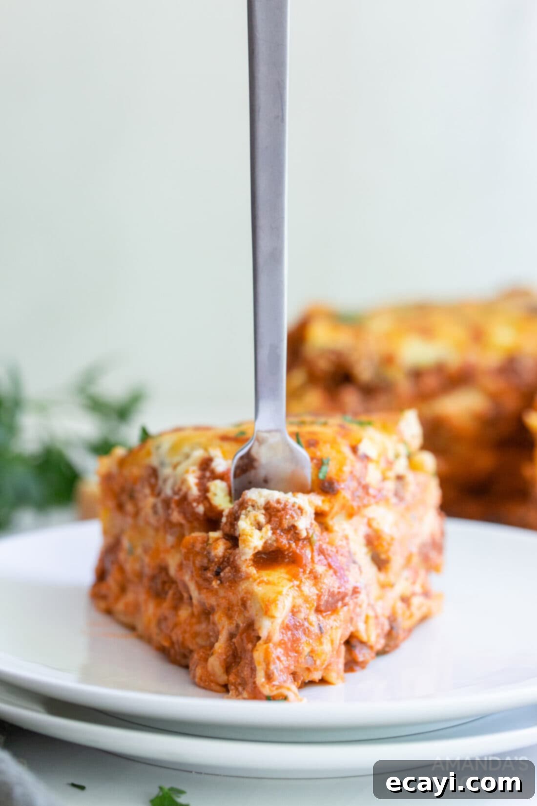 Quick Instant Pot Lasagna 13 Fork digging into a perfectly baked slice of Instant Pot Lasagna, showing the delicious layers.