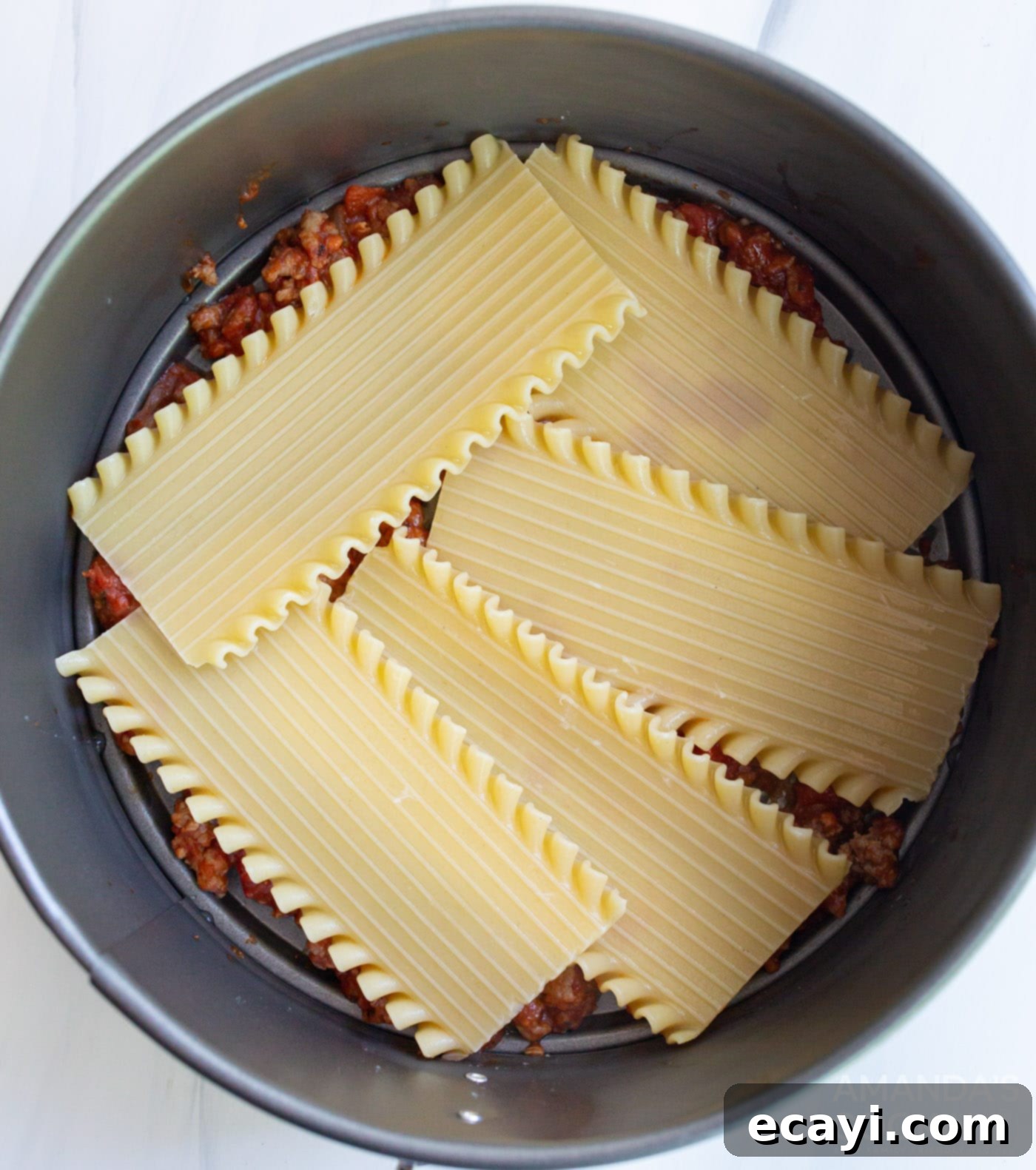 Quick Instant Pot Lasagna 8 Lasagna noodles arranged in a springform pan.