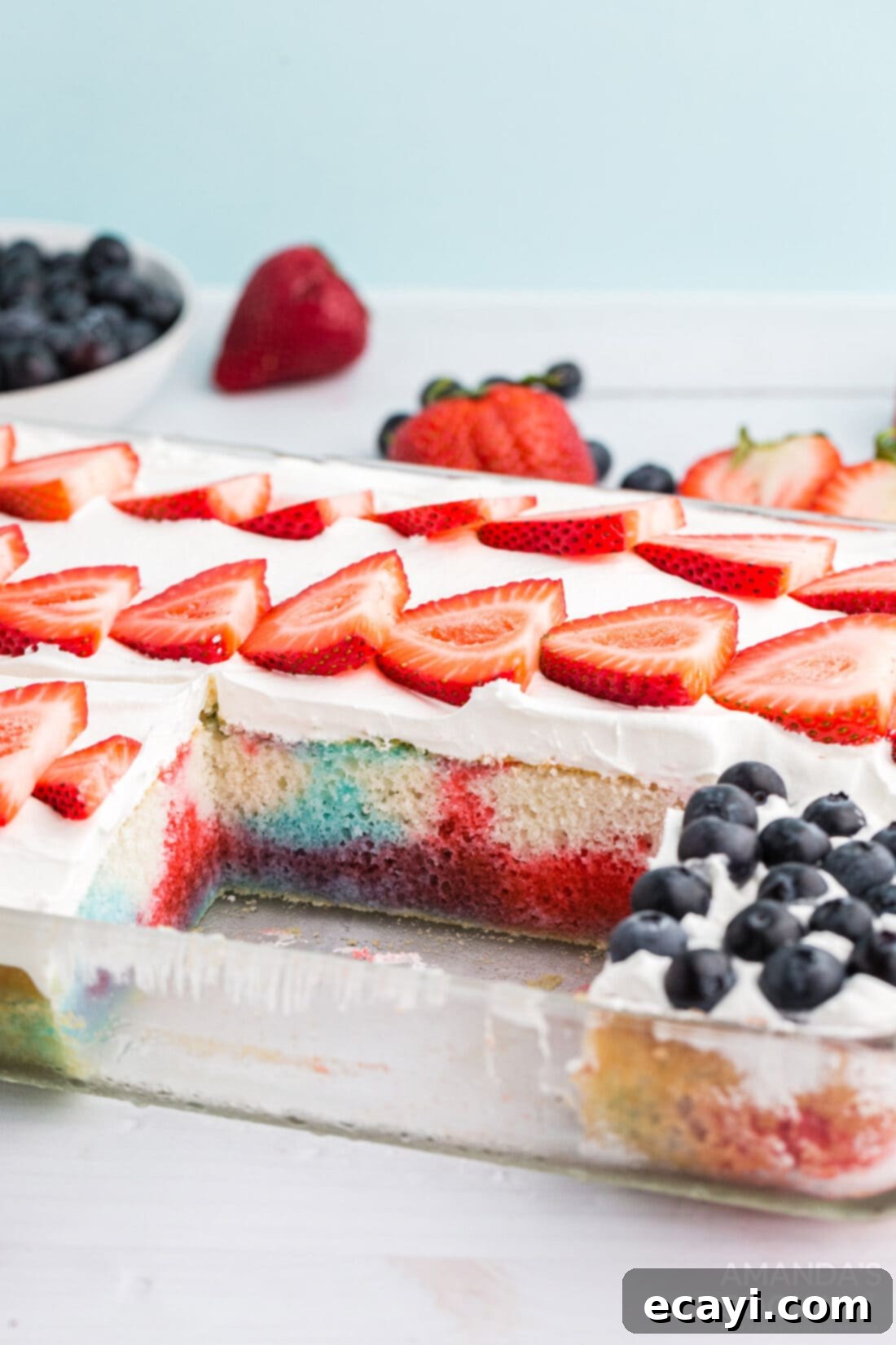 Patriotic Red, White and Blue Poke Cake 11 A delicious slice of US flag poke cake removed from the pan, showing the red and blue jello layers.