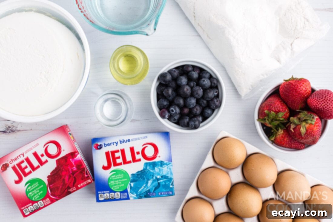 Patriotic Red, White and Blue Poke Cake 4 Arrangement of ingredients needed for a patriotic American flag poke cake, including cake mix, Jell-O boxes, Cool Whip, strawberries, and blueberries.