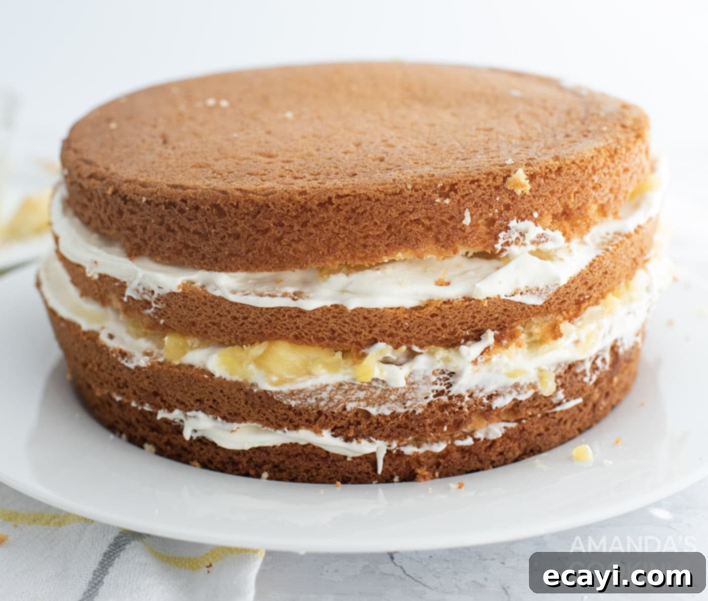 Golden Pineapple Bliss 9 A multi-layered pineapple cake with creamy filling and crushed pineapple between each layer.