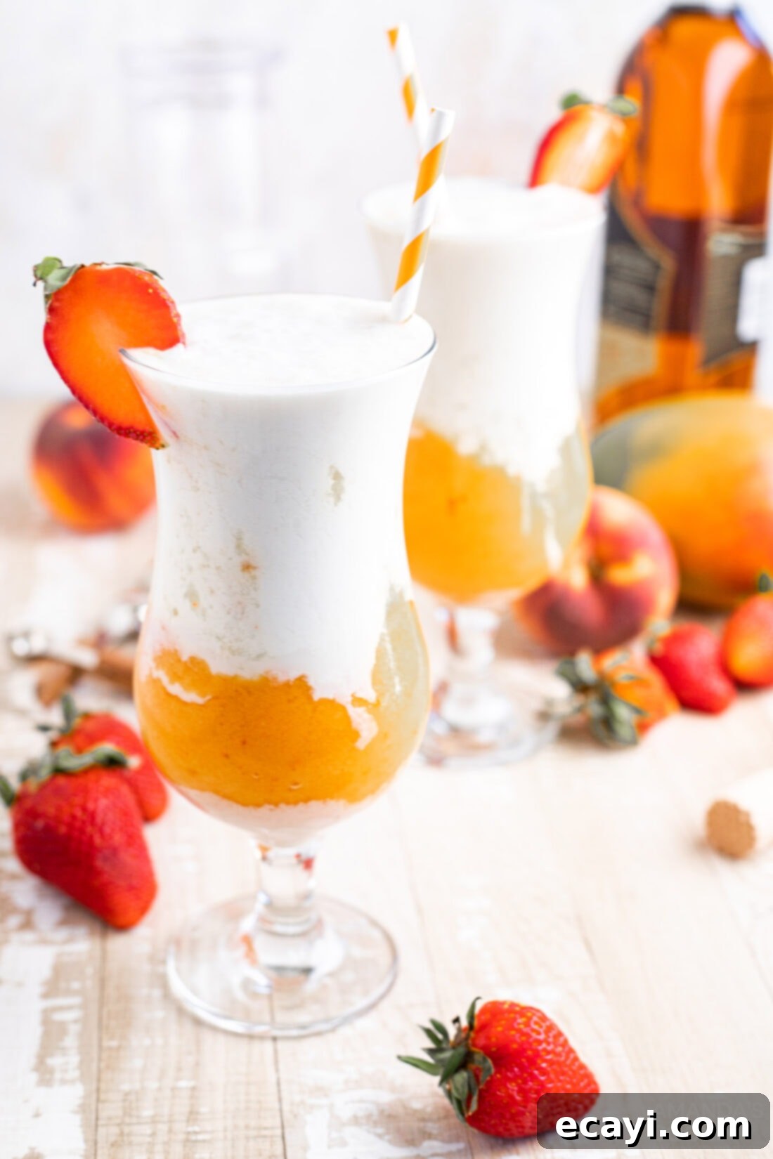 Island Vibes Rum Slush 3 Close-up of a Tropical Rum Slush in a tall glass with a straw, showcasing the beautiful two-toned layers and frosty texture, ready to drink.