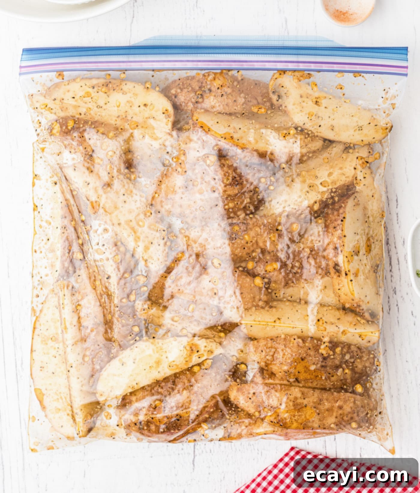 Golden Spiced Wedges 7 Potato wedges with seasoning in a Ziploc bag