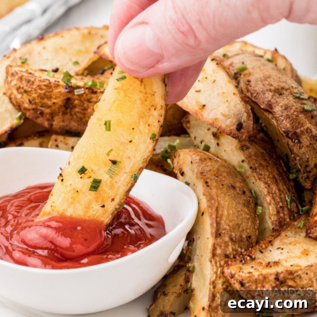 Golden Spiced Wedges 10 Dipping a potato wedge in ketchup