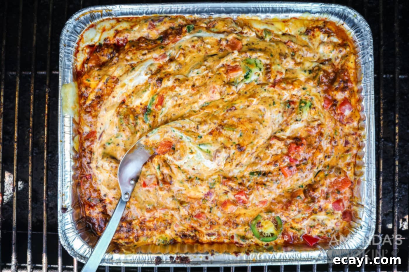 Decadent Smoked Cheese Dip 5 finished smoked queso dip in a pan inspired by tik tok