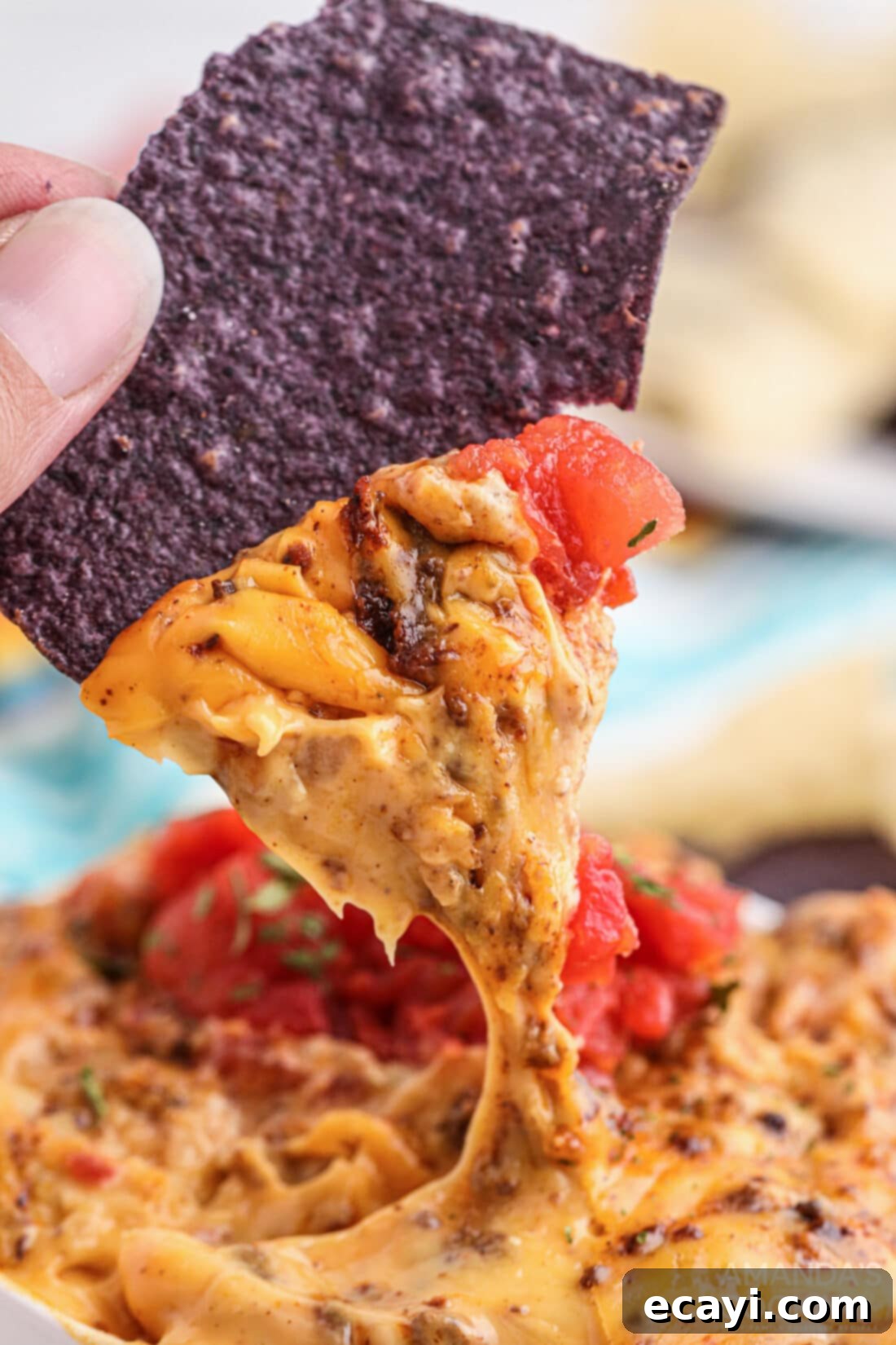 Decadent Smoked Cheese Dip 6 dipping chip into Smoked Queso Dip