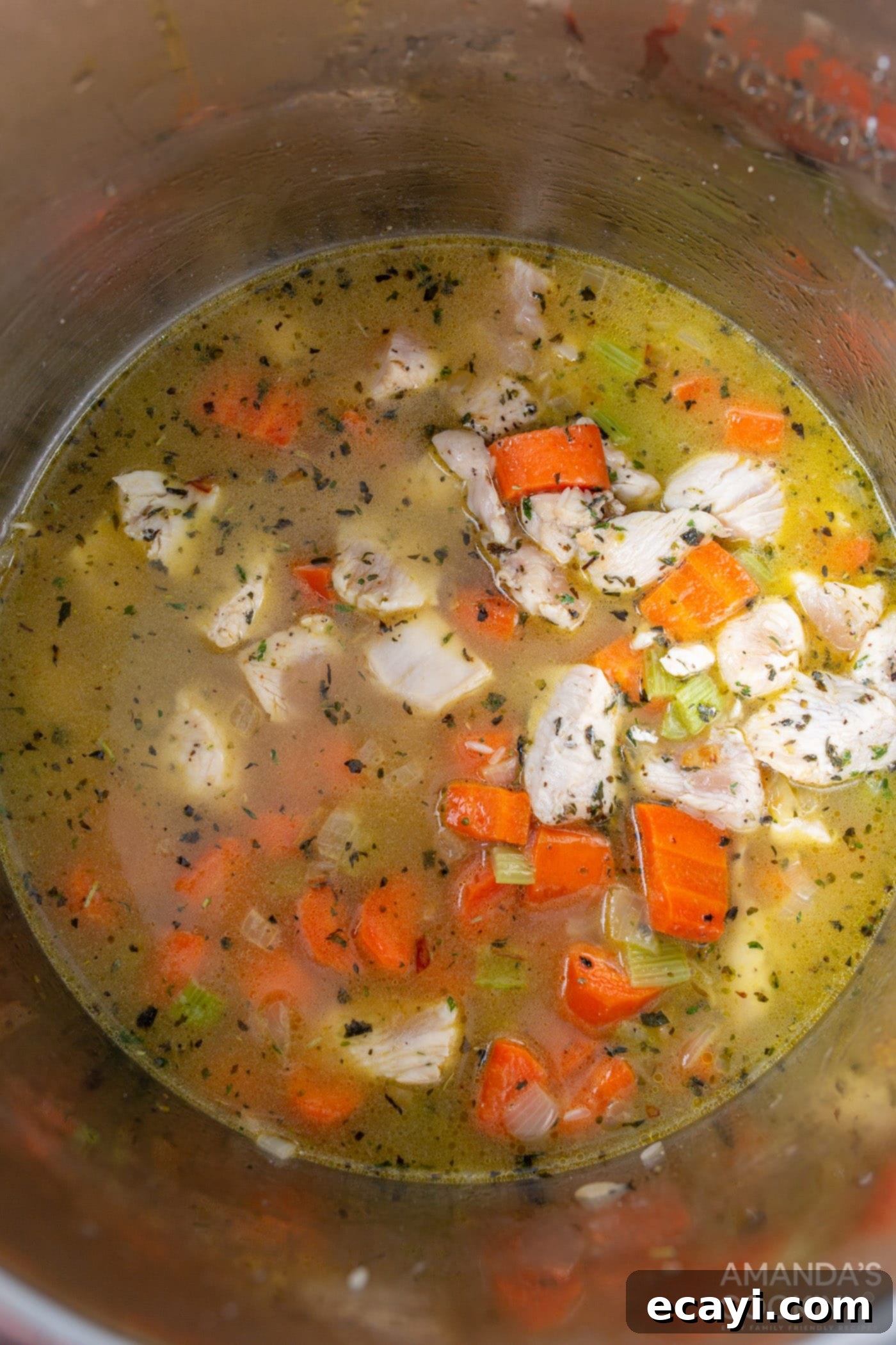 Effortless Instant Pot Chicken and Rice 7 Chicken stock added to rice, chicken, and vegetables in the Instant Pot, ready for pressure cooking