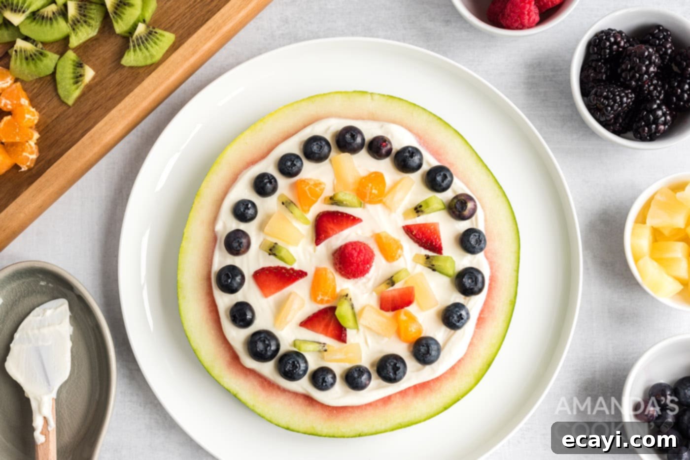 Watermelon Wonder Wheels 12 A beautifully decorated watermelon slice covered with a variety of fresh fruits and a creamy yogurt topping.