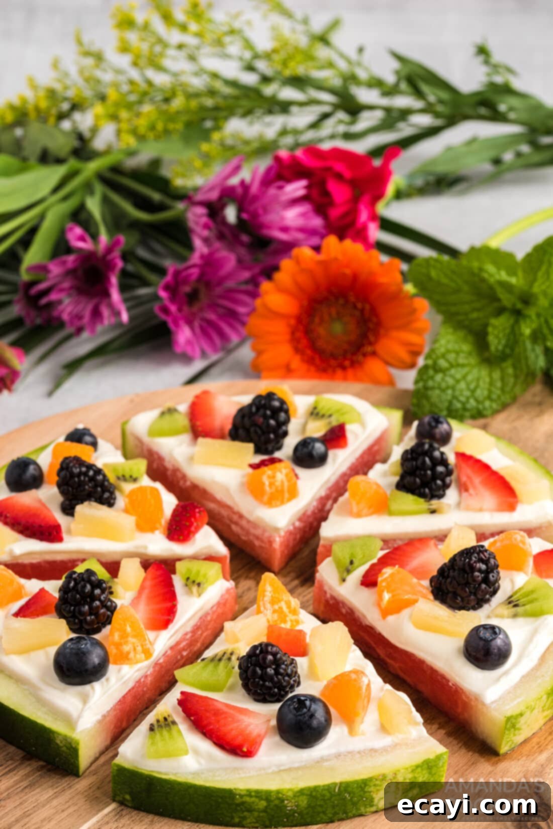 Watermelon Wonder Wheels 13 A beautifully arranged Watermelon Pizza, showcasing its colorful fruit toppings and creamy spread, ready to be served.
