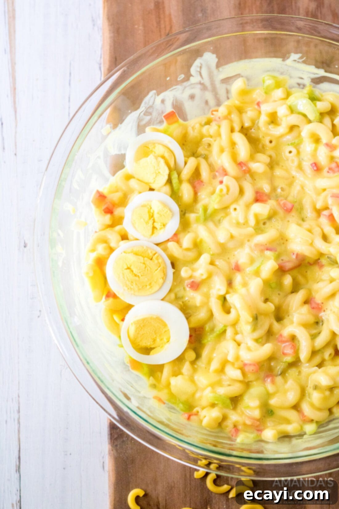 Creamy Amish Macaroni Perfection 2 A vibrant bowl of creamy Amish Macaroni Salad, artfully garnished with slices of hard-boiled egg and a sprinkle of paprika, ready to be served at a family gathering or potluck.