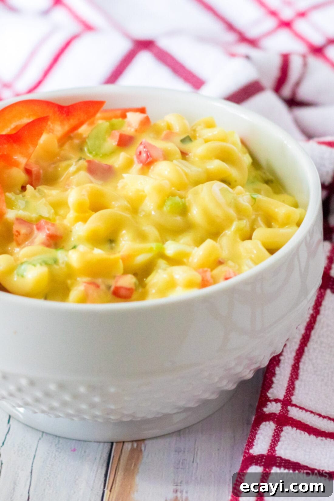 Creamy Amish Macaroni Perfection 6 An enticing close-up of Amish Macaroni Salad in a serving bowl, showcasing its creamy texture, colorful vegetables, and tender macaroni, ready to be enjoyed.