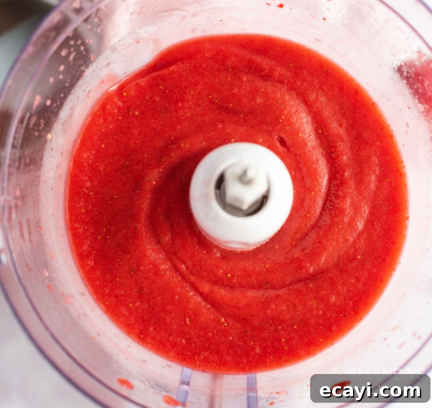 Summer Strawberry Bundt Delight 5 strawberries being pureed in food processor