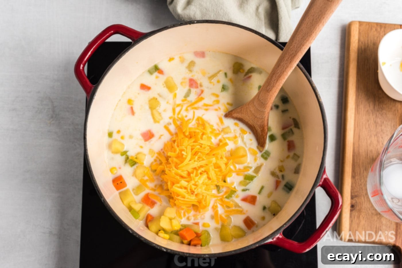 Creamy Corn Chowder 8 milk and cheese added to saucepan of corn chowder soup