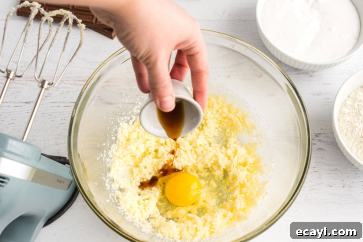 Ultimate Smores Bars 6 adding vanilla to eggs in bowl
