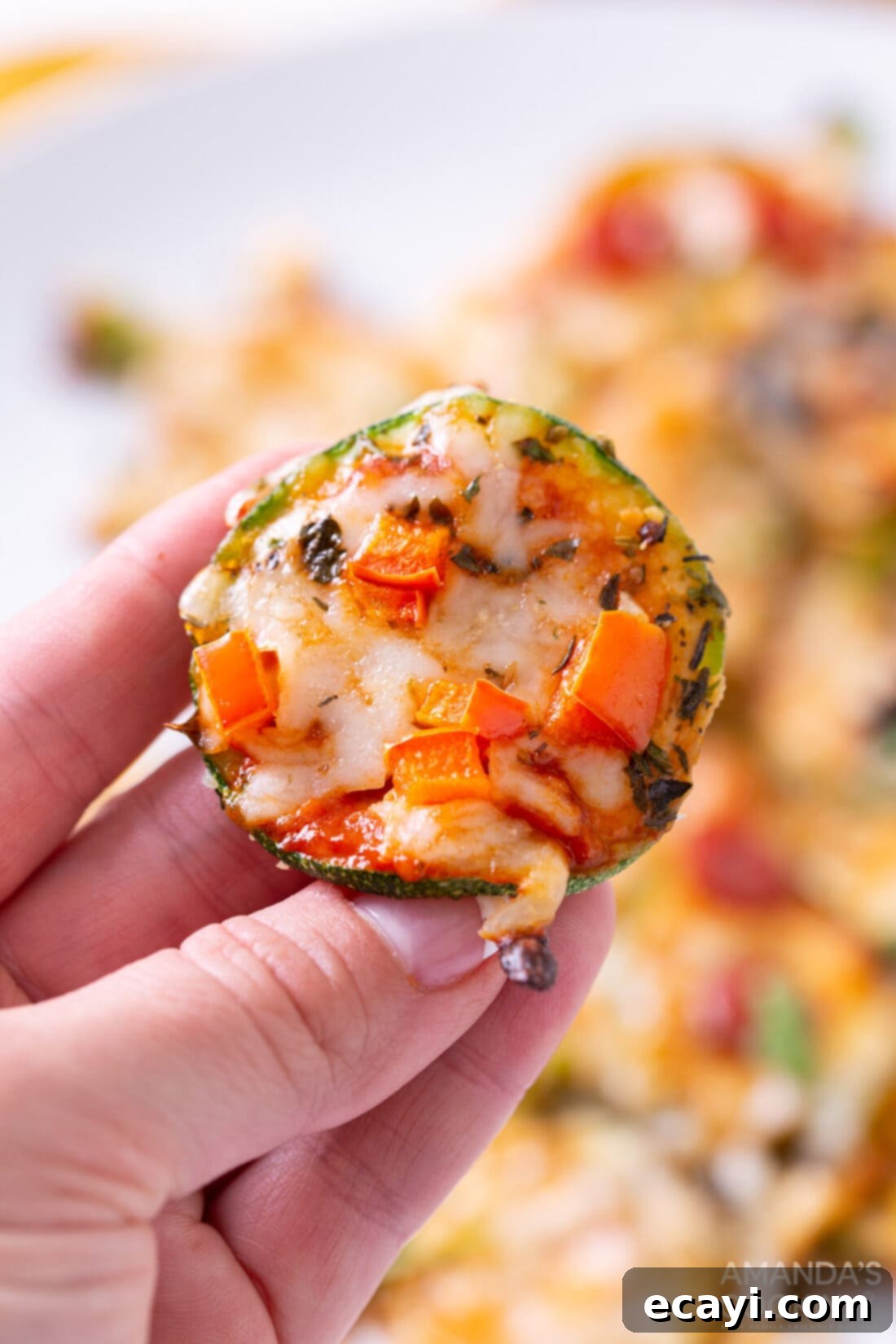 Zucchini Pizza Bites 8 holding a Zucchini Pizza Bite