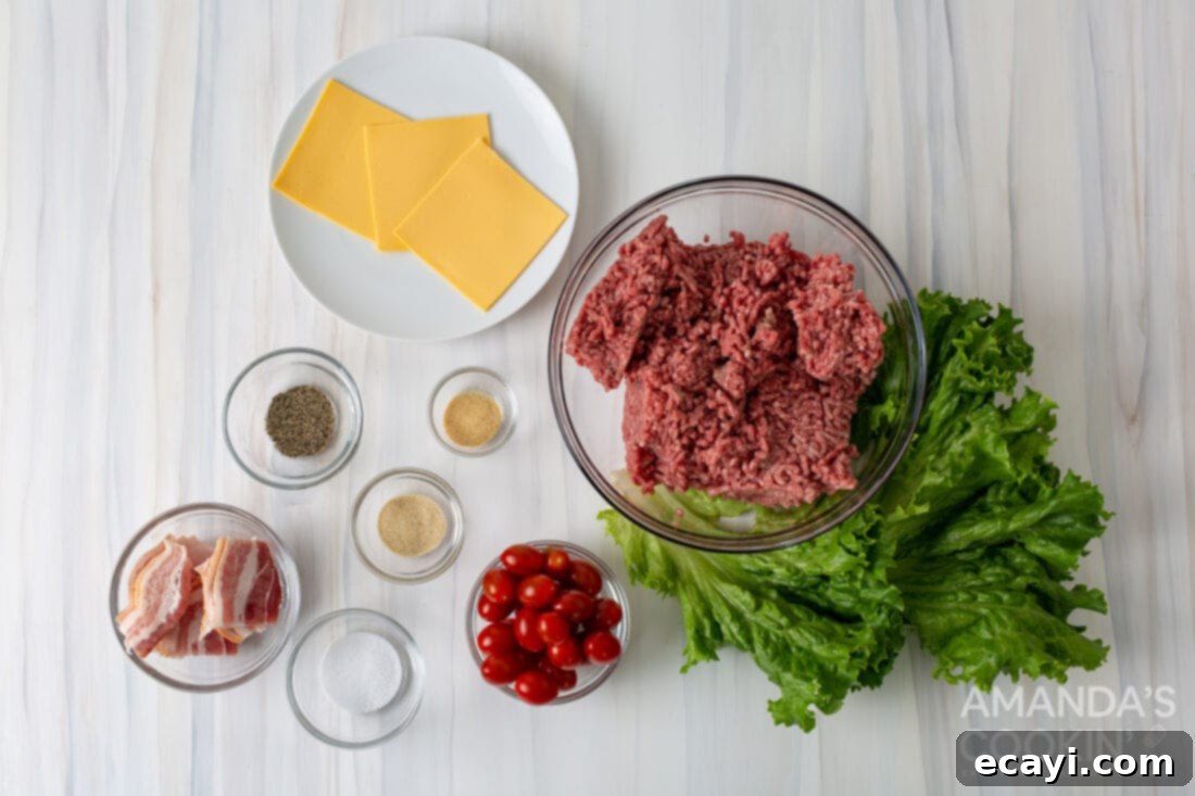 Mini Bacon Cheeseburger Poppers 4 A vibrant display of fresh ingredients for Bacon Cheeseburger Meatballs, including ground beef, American cheese, crisp lettuce, cherry tomatoes, and strips of bacon.