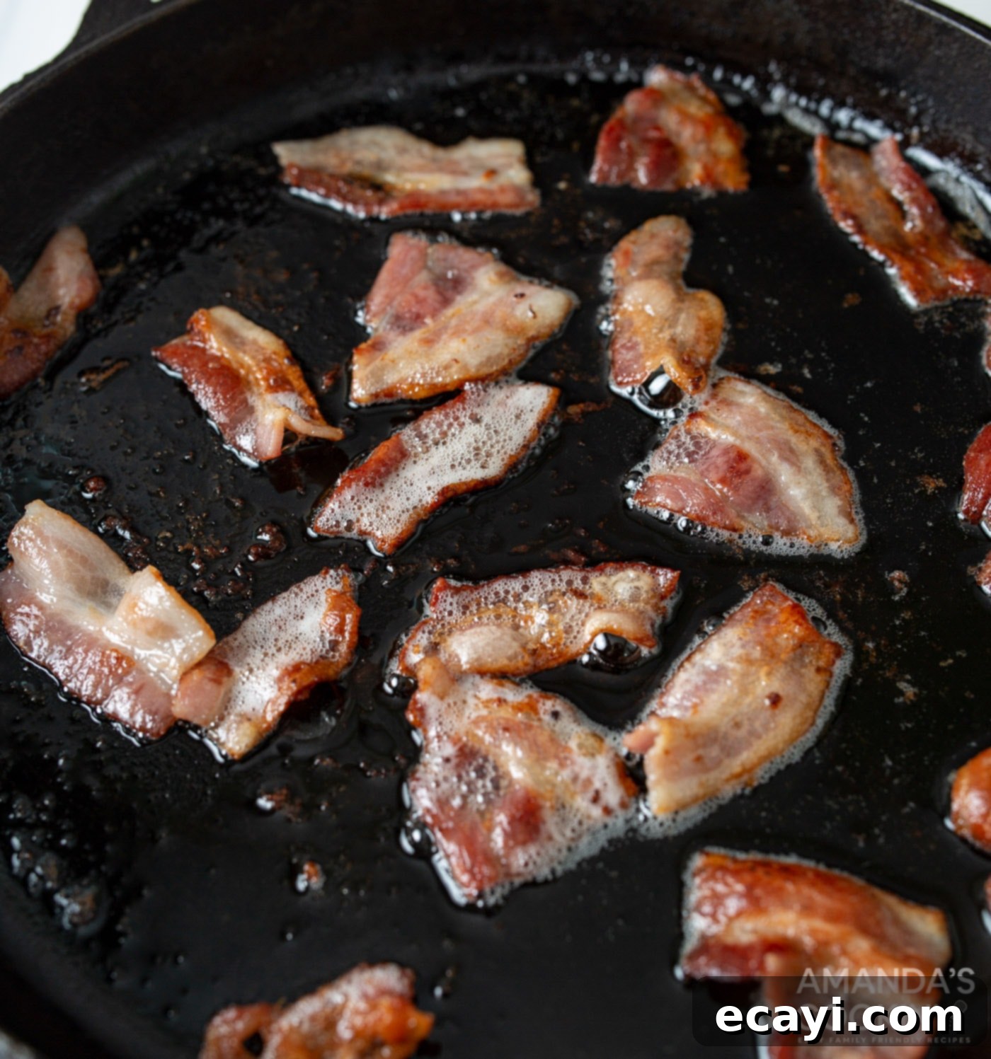 Mini Bacon Cheeseburger Poppers 7 Crispy bacon pieces sizzling in a hot skillet, soon to be part of the delicious cheeseburger meatballs.
