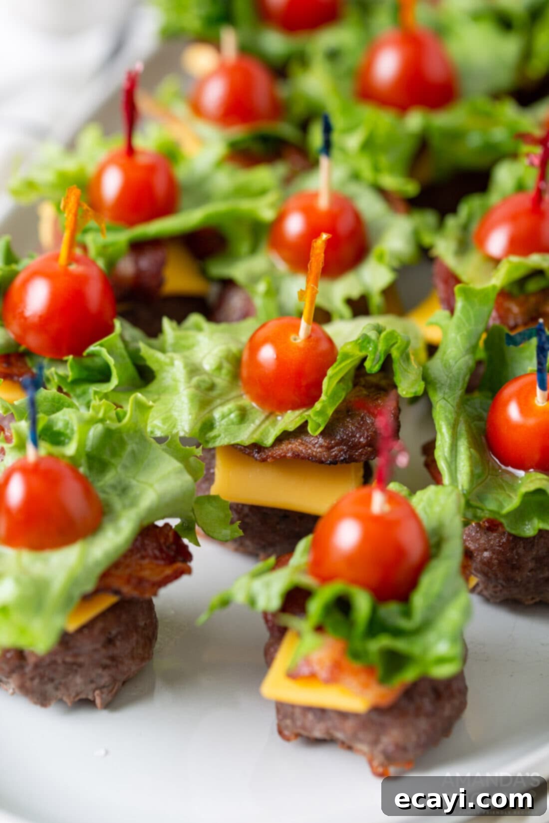 Mini Bacon Cheeseburger Poppers 10 A festive platter generously filled with Bacon Cheeseburger Meatball appetizers, perfectly arranged for a party spread.