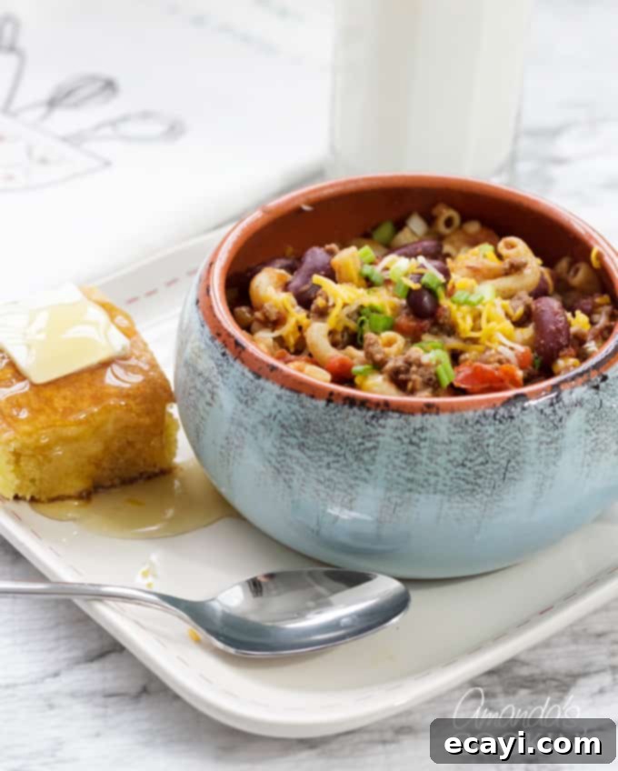 Chili Mac with Cornbread A bowl filled with rich chili mac, served alongside a slice of golden cornbread, ready to be enjoyed.