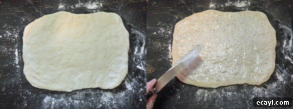 Parmesan Garlic Rolls A rectangular piece of Parmesan Garlic Roll dough, prepared on a floured surface.