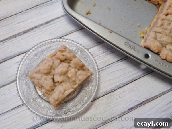Crumb Cake for Serving An overhead shot of several slices of homemade crumb cake arranged artfully on a clear serving plate, ready to be enjoyed.