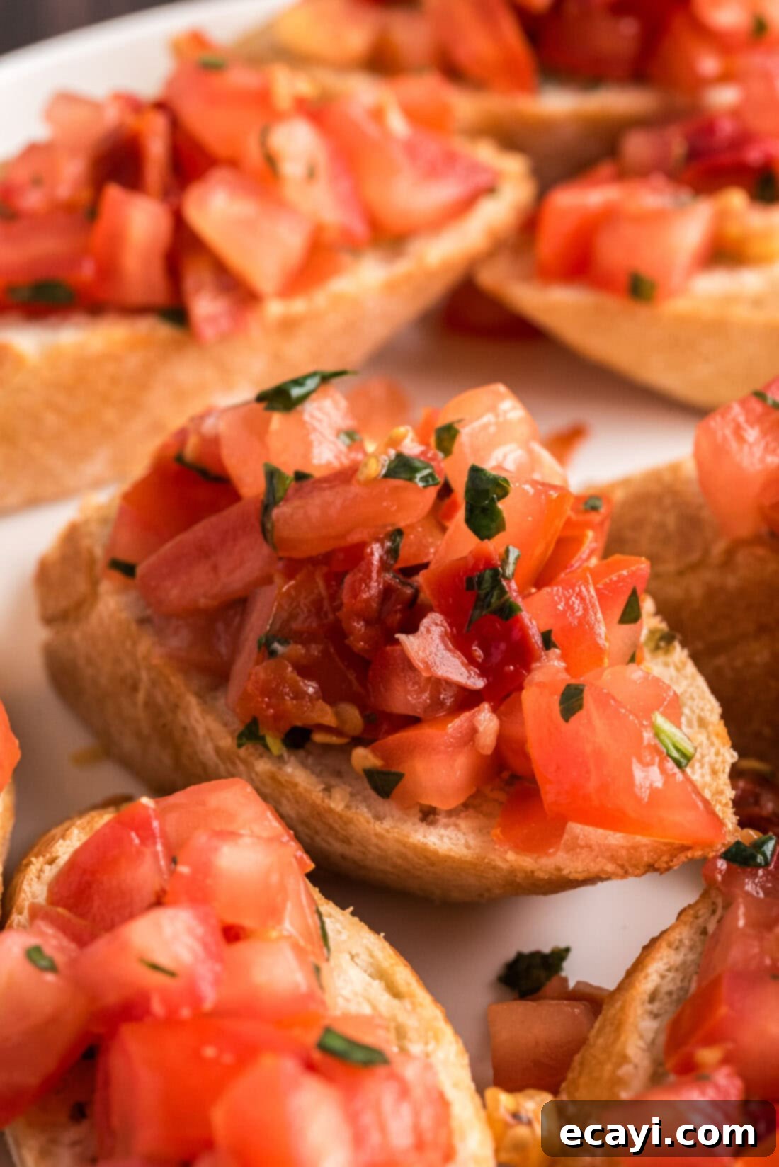 Crafting Perfect Bruschetta 10 A close-up shot of freshly prepared bruschetta on toasted baguette slices, showcasing the vibrant tomato and basil topping.